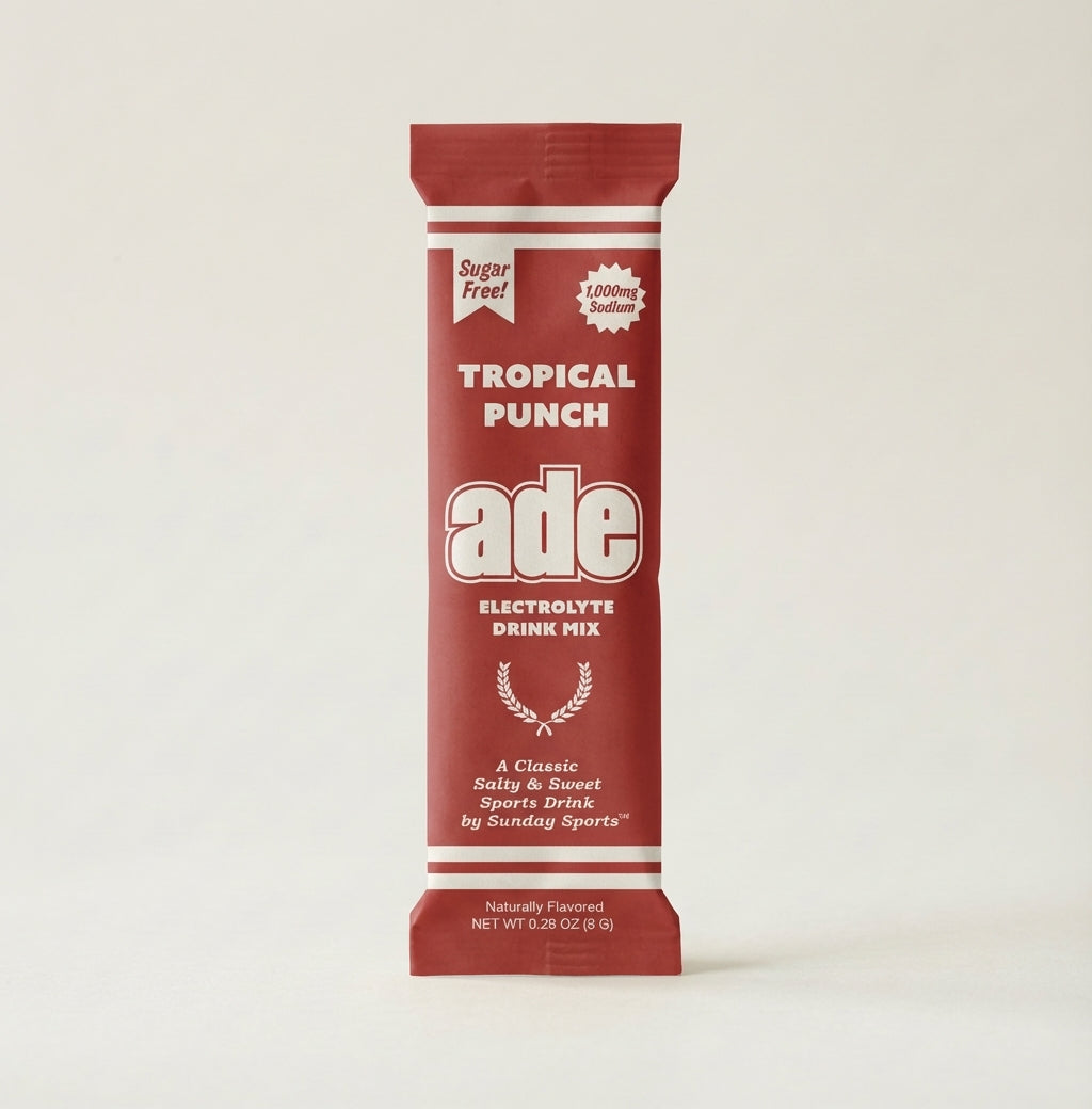 Red and white electrolyte drink mix package for tropical punch on a beige background, bundle-selector
