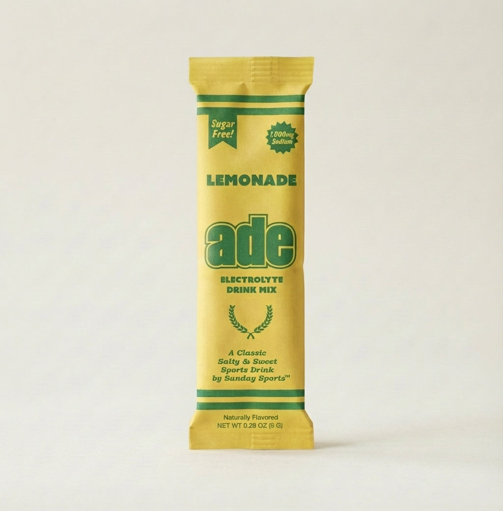 Yellow and green package of ade Lemonade electrolyte drink mix on a white background, bundle-selector